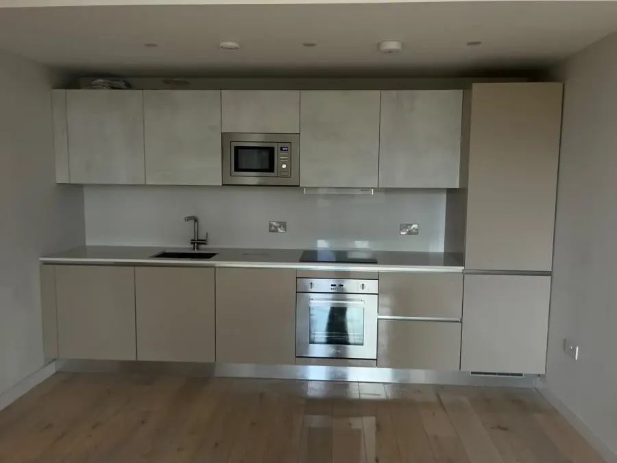 Modern kitchen with clean units and a wooden floor