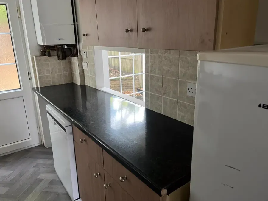 Kitchen with polished black worktops after cleaning