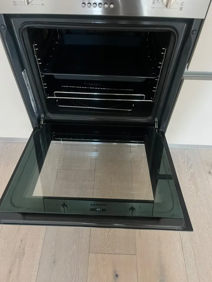 The same oven clean inside with racks and glass door degreased